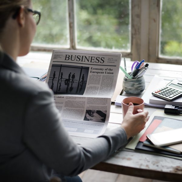 businesspeople-reading-newspaper-at-office-updating-news.jpg